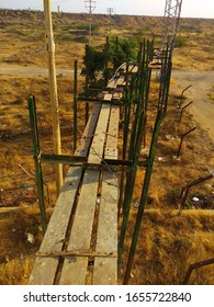 A Maintenance Bridge Made Up Of Wooden Planks For A High Tension Electrical Line