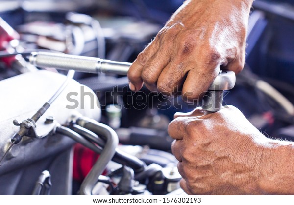 maintenance car using screwdriver. dirty man\
hands holding tools fixing repair car engine.\
Close up mechanical\
man dirty hands holding tools using screwdriver maintenance car\
vehicle service.