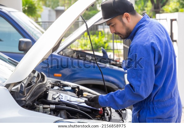 maintenance car using screwdriver. mechanic man\
hands holding tools fixing repair car engine.\
mechanical holding\
wrench check up car vehicle\
service.
