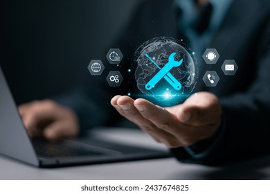 Maintenance concept. Repair about assistance and servicing of equipments, technical support, assistance and service. Businessman using laptop with maintenance icon on virtual screen. - Powered by Shutterstock