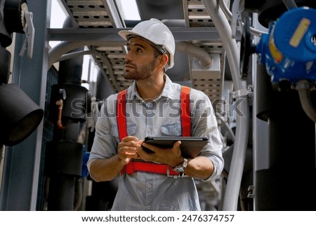 Maintenance engineer is checking cooling system at rooftop building. Blue collar worker and engineer.