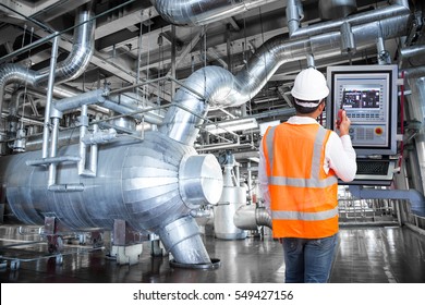 Maintenance engineer looking at monitor control in thermal power plant factory