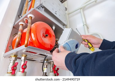 Maintenance Engineer Is Servicing Domestic Central Gas Heating Boiler. Repair Of The Heating System At Home