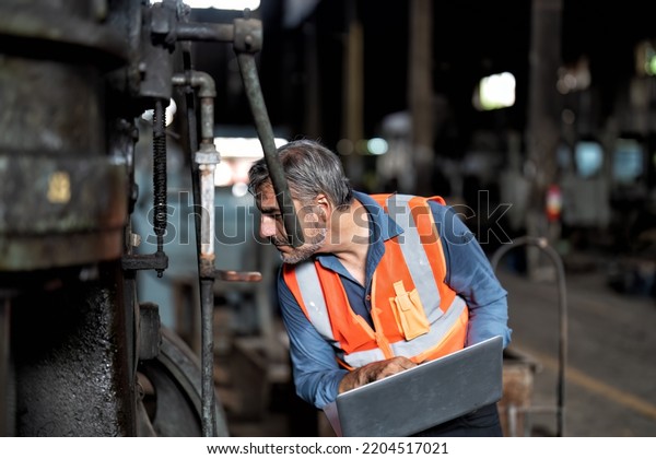 maintenance engineer\
smiling hold the computer tablet pc online social media checking\
news and\
information