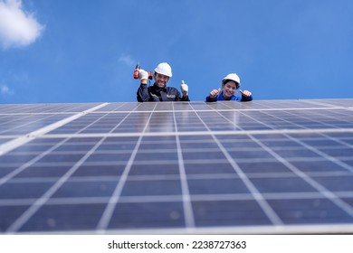 Maintenance engineer at solar farm stand on scissor lift inspection solar panel smile portrait - Shutterstock ID 2238727363