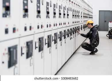Maintenance engineer testing medium voltage switchgear and bay control unit. Relay protection system