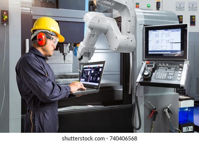 Maintenance engineer using laptop computer control automatic robotic hand with CNC machine in smart factory, Industry 4.0 concept - Shutterstock ID 740406568