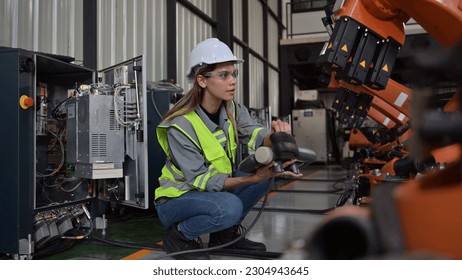 Maintenance engineer worker working with robotic machine at factory