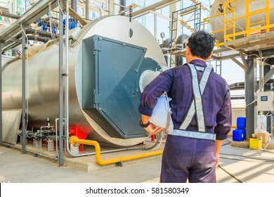 Maintenance engineer working with gas boiler of heating system equipment in a boiler room