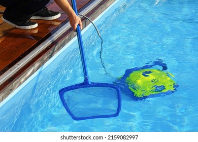 Maintenance Pool Cleaner During His Work. Hotel Staff Worker Cleaning The Pool