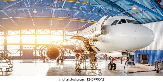 Maintenance and repair of aircraft in the aviation hangar of the airport, view of a wide panorama