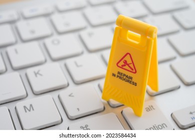 Maintenance, Repair, Update Software In Computer System From Virus Or Ransomware Concept. Close Up Yellow Warning Sign 