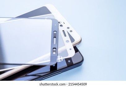 maintenance and repairing smartphones. many tempered glass screen protector and mobile phone, replace concept. mobile screen replacement protector, repair kit. installation of protective cover film - Shutterstock ID 2154454509