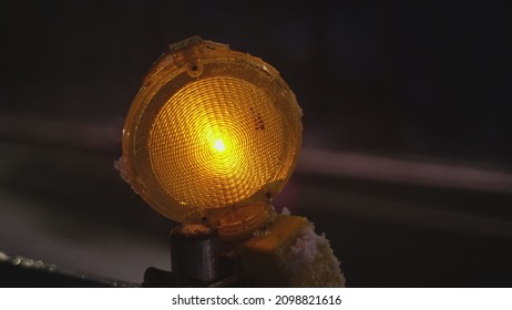 Maintenance Roadworks Barrier Orange Caution Lamp Pulsing In Sequence By Busy Icy Road With High Congestion Traffic On Winter Evening