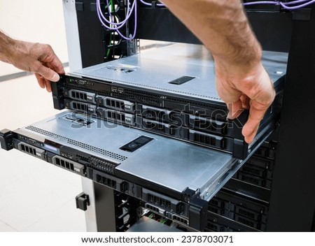 Maintenance of servers installed in a rack in the server room. The engineer pulled out the server blocks