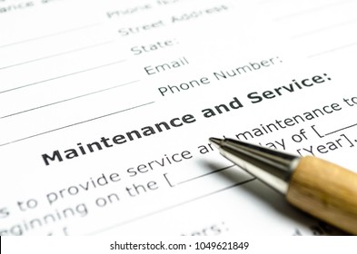 Maintenance and service contract with wooden pen - Shutterstock ID 1049621849