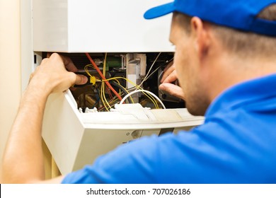 Maintenance Service Engineer Working With Home Gas Heating Boiler