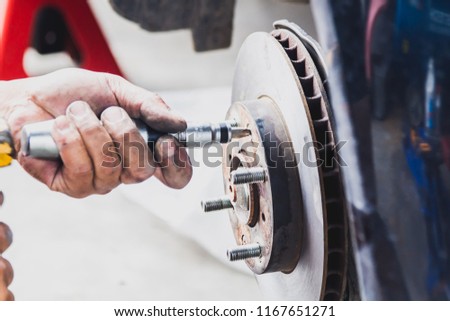Maintenance technicians are replacing brake the vehicle. For safe driving , soft focus , blurred.