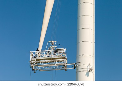 Maintenance Of A Wind Turbine Against A Clear Blue Sky