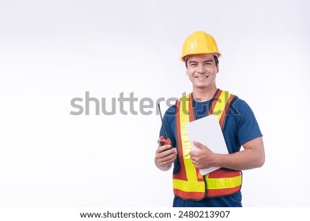 Maintenance workman occupation technology concept. Handsome confident craftsman wear yellow helmet hard hat safety talking with walkie talkie while looking tablet standing over isolated background.