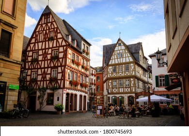MAINZ, GERMANY, AUGUST 20, 2020: Old town in Mainz with restaurants and cafes where people sit outside with typical half-timbered houses, Germany