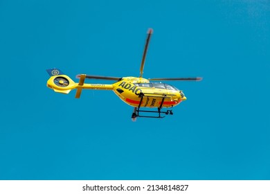 Mainz, Germany - March, 2022: ADAC, Paramedic Rescue Helicopter Against Blue Sky. Starting Helicopter, Flying Ambulances, Air Ambulance In Germany. Emergency Doctor. View From Below