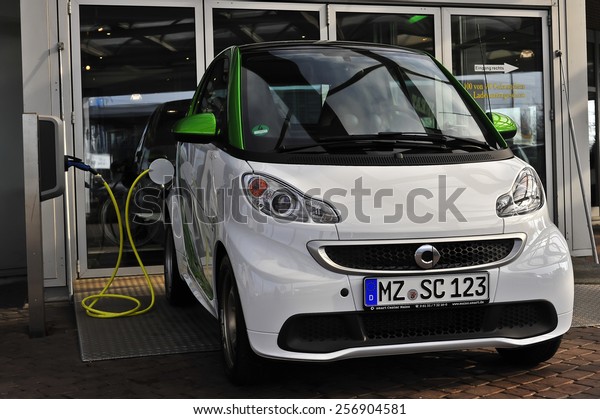 MAINZ,GERMANY-FEB 20:green energy and white Smart\
Car on February 20,2015 in Mainz, Germany.Smart Automobile is a\
division of Daimler AG that manufactures and markets the Smart\
Fortwo.
