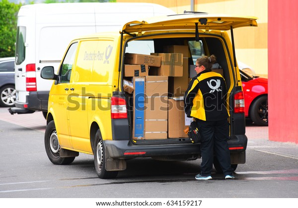 MAINZ,GERMANY-MAY 05:DEUTSCGHE\
POST courier delivers parcels to customers  on May 05,2017 in\
Mainz,Germany.