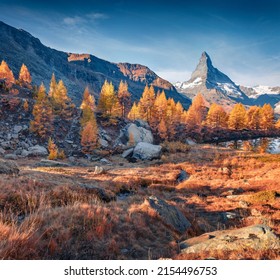 Majestic autumn view of Matterhorn peak, Zermatt location, Switzerland, Europe. Colorful morning view of Grindjisee lake in Swiss Alps. Beauty of nature concept background.