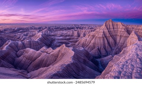 Majestic Badlands Landscape at Sunset with Vibrant Purple and Pink Sky - Powered by Shutterstock