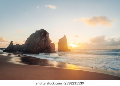 majestic cliffs and golden sands of Praia da Ursa in Sintra, Portugal, waves crash against stunning rock formations during a tranquil sunset - Powered by Shutterstock