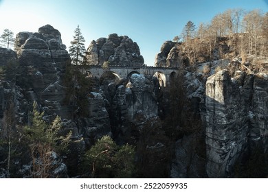 Majestic cliffs and a historic bridge in the winter landscape of the Bastei region, Switzerland - Powered by Shutterstock