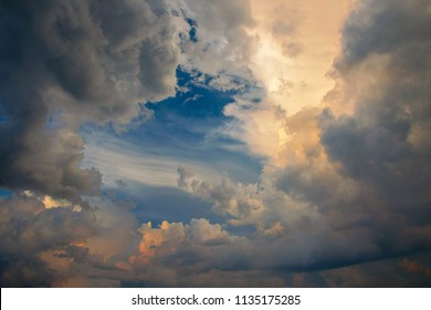 Majestic Clouds Illuminated By Sunset Light. Gloomy Rainy Sky With A Bright Cloud. Abstract Background. Picture Of Cloud Computing Concept