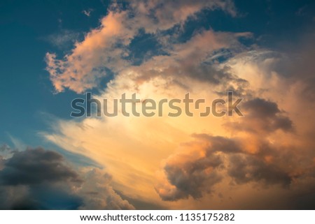 Majestic clouds illuminated by sunset light. Gloomy rainy sky with a bright cloud. Abstract background. Picture of cloud computing concept