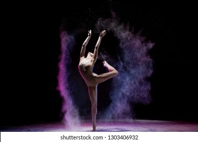 Majestic dancing woman in colorful flying powder