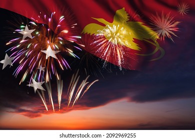 Majestic fireworks in evening sky and flag of Papua New Guinea for Independence day or National Holiday