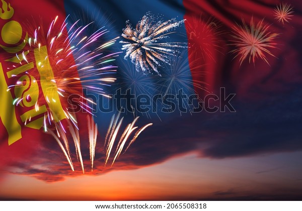Majestic fireworks in evening sky and flag of\
Mongolia for Independence\
day