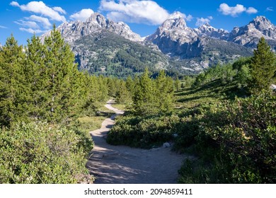 The majestic Grand Tetons mountains as seen from the Taggart Lake trail in Grand Teton National Park - Shutterstock ID 2094859411