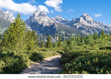 The majestic Grand Tetons mountains as seen from the Taggart Lake trail in Grand Teton National Park