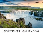 Majestic landscape of Godafoss waterfall or waterfall of the gods flowing and colorful sunset sky on Skjalfandafljot river in summer at Northern Iceland