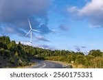 Majestic landscape of mountain top with industrial or wind turbine or wind power plant. Concept of energy and progress, as the turbines harness the power of the wind to generate electricity.