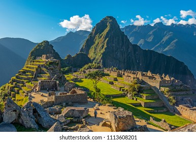 The majestic Machu Picchu at sunset with the last tourists in the lost city of the Inca, Cusco region, Peru, South America.
