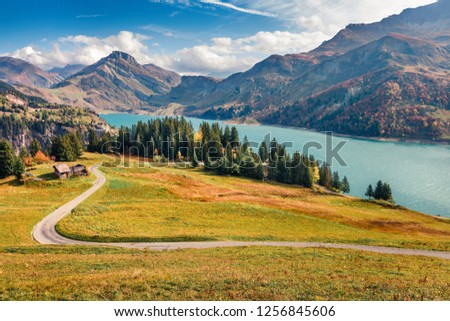 Majestic morning view of Roselend lake/Lac de Roselend. Picturesque autumn scene of Auvergne-Rhone-Alpes, France, Europe. Beauty of nature concept background. Amazing world of Alpine Mountains.