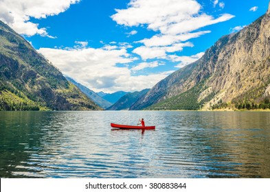 Majestic mountain lake in Canada. Seton Lake in British Columbia, Canada. Red canoe. - Powered by Shutterstock