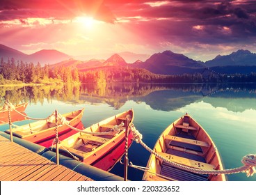 Majestic mountain lake in National Park High Tatra. Dramatic unusual scene. Sky glowing by sunlight. Strbske pleso, Slovakia, Europe. Beauty world. Retro style filter. Instagram toning effect. - Powered by Shutterstock