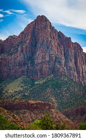 Majestic Mountain Pointing Towards Sky With Red Rock Face.