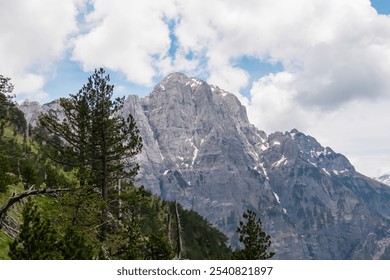 Majestic mountain ridge Maja Boshit towering over rugged landscape in Albanian Alps (Accursed Mountains) in Northern Albania. Scenic hiking trail from Valbona to Theth. Wanderlust in alpine wilderness - Powered by Shutterstock