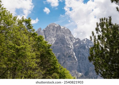 Majestic mountain ridge Maja Boshit towering over rugged landscape in Albanian Alps (Accursed Mountains) in Northern Albania. Scenic hiking trail from Valbona to Theth. Wanderlust in alpine wilderness - Powered by Shutterstock