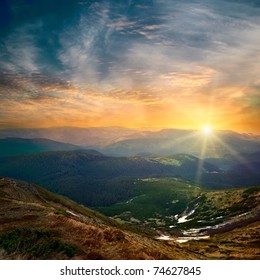 Majestic Mountain Sunset And Colored Sky With Clouds