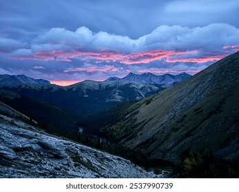 Majestic Mountain Sunset with Dramatic Pink and Purple Sky Over Rocky Landscape - Powered by Shutterstock